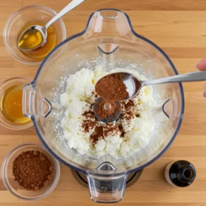 Blending cottage cheese until smooth for creamy mousse texture

